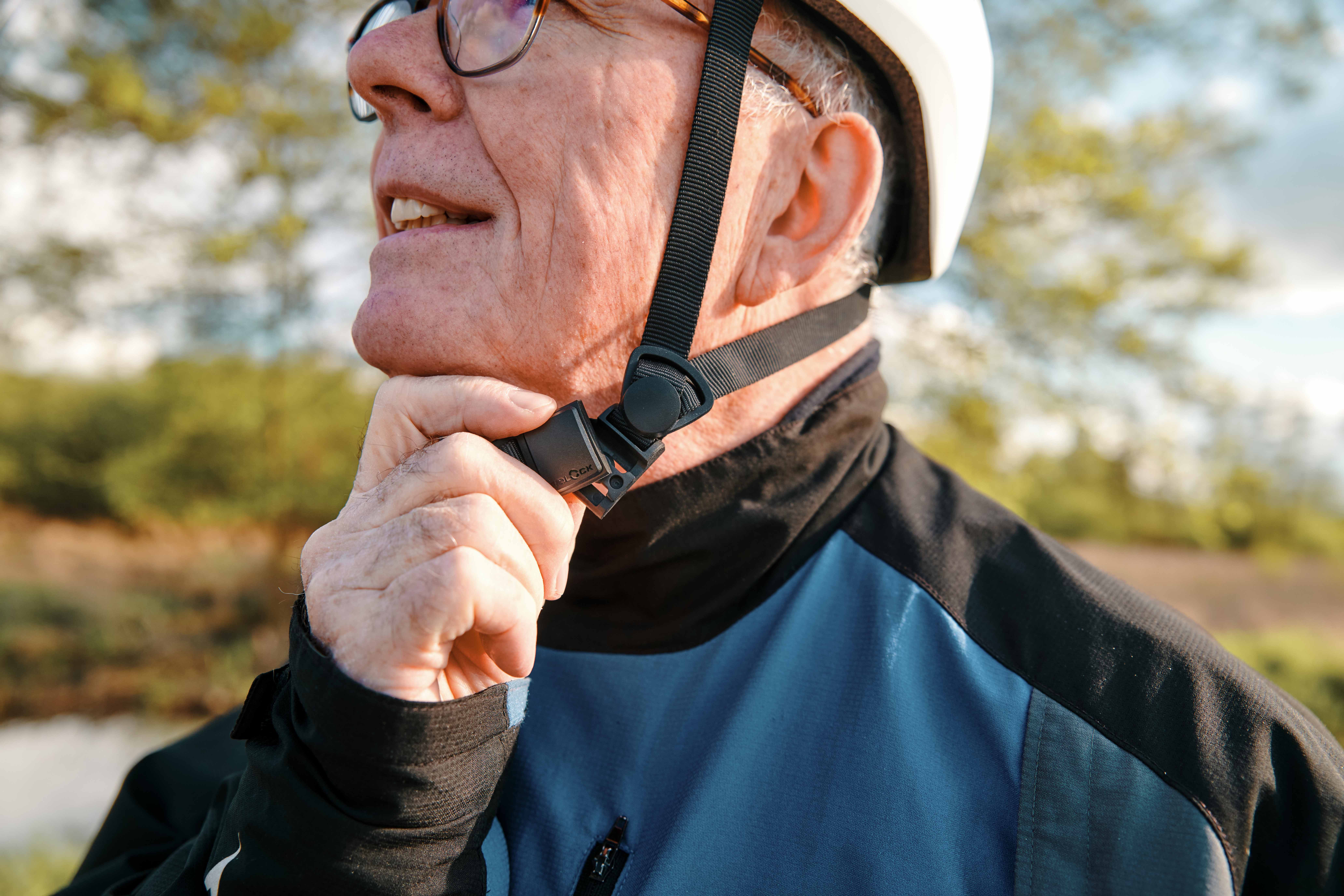 Elderly man opening helmet