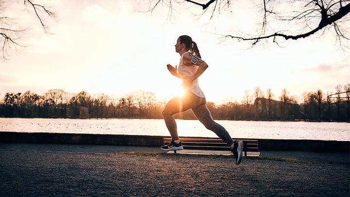 Woman on a run at a lake - fasteners for sports