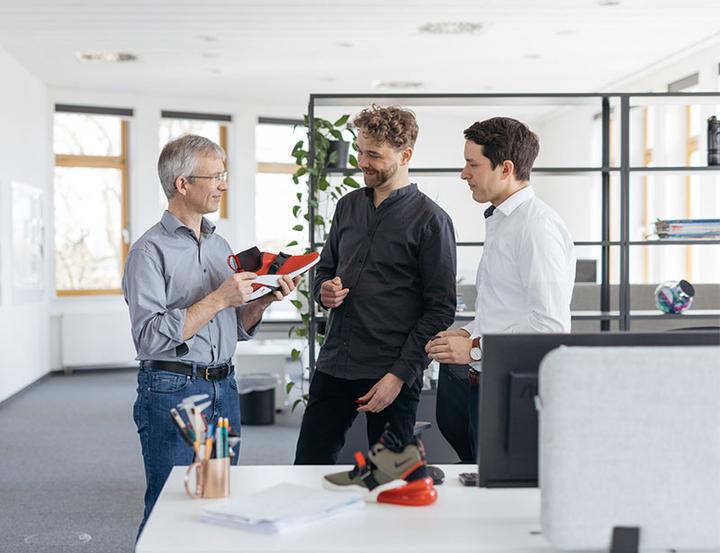 Joachim Fielder discussing products with two of his team members